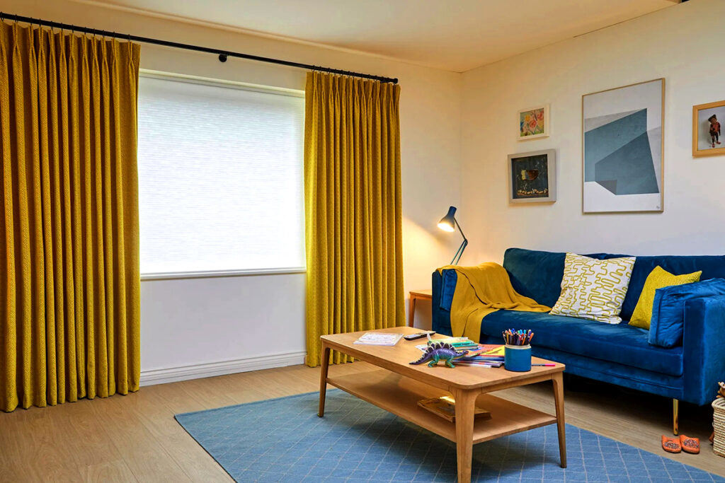 Living-Room-with-Yellow-Curtains and Blue Sofa